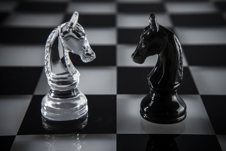 chess pieces on a glass board